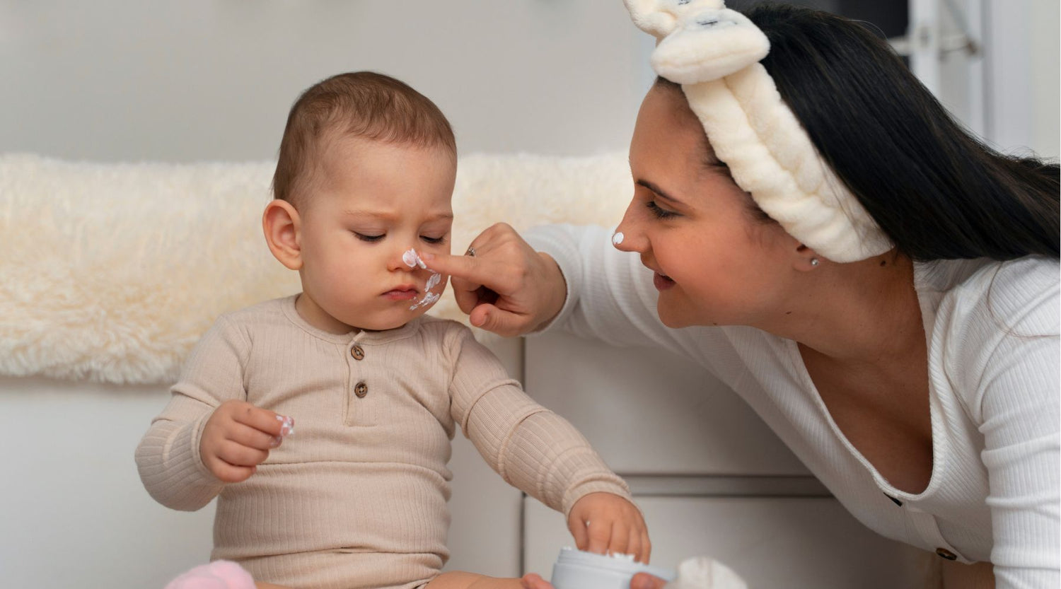 mother giving baby skin care with QV Baby