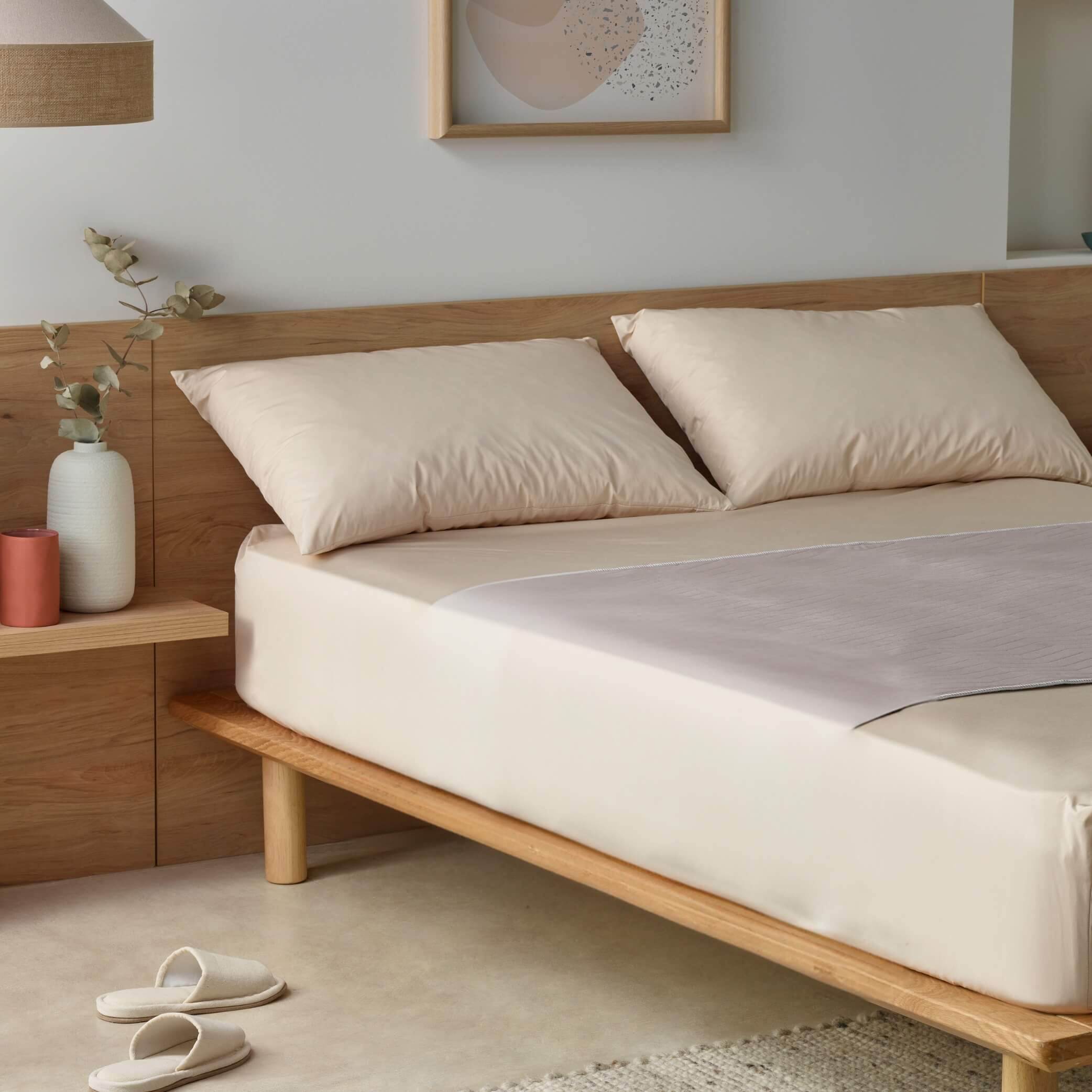 Kylie bed pad in clay styled on a beige color bed sheets from Staydry, no wings.