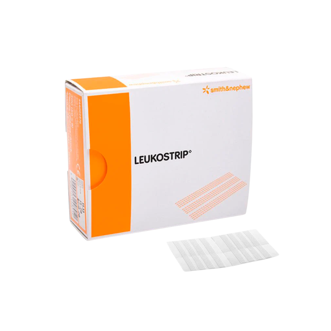 Smith & Nephew Leukostrip Wound Closure Strips retail box on a gray background, with a sheet of adhesive strips lying in front of the box.