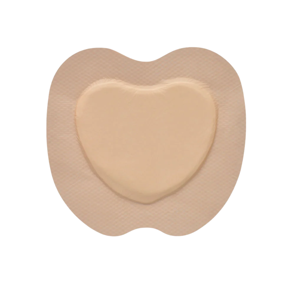 Close-up view of the beige, heart-shaped Osmocel Si Silicone Hydrophorous Foam - Sacral Bordered dressing.